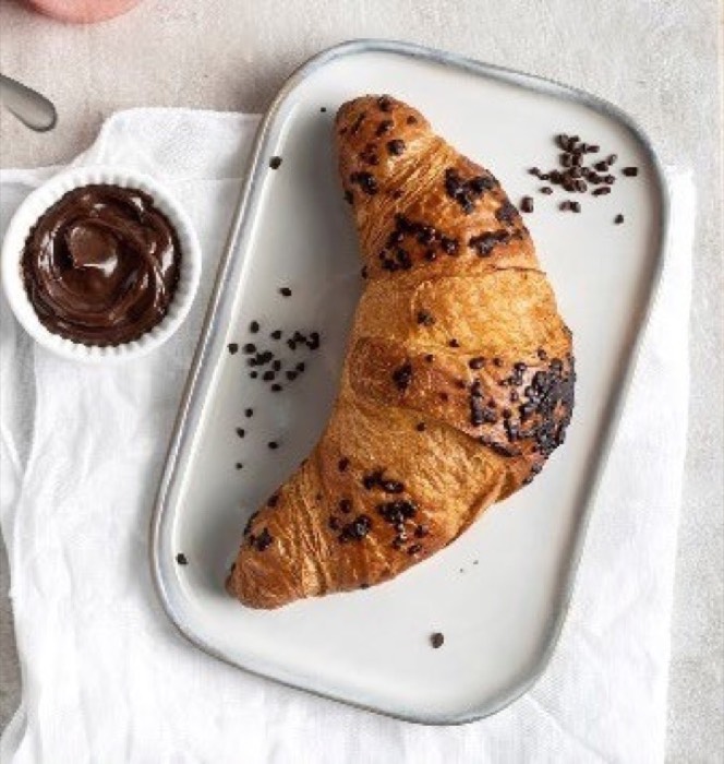 Chocolate hazelnut croissant on a serving tray