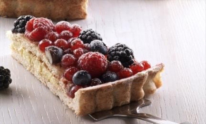 Mixed berry tart slice topped with raspberries, blackberries and red currants